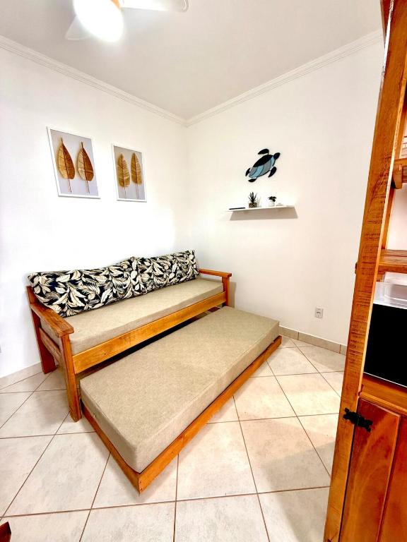 a room with a bed in the corner of a room at Apartamento à beira-mar Ilha Comprida in Ilha Comprida