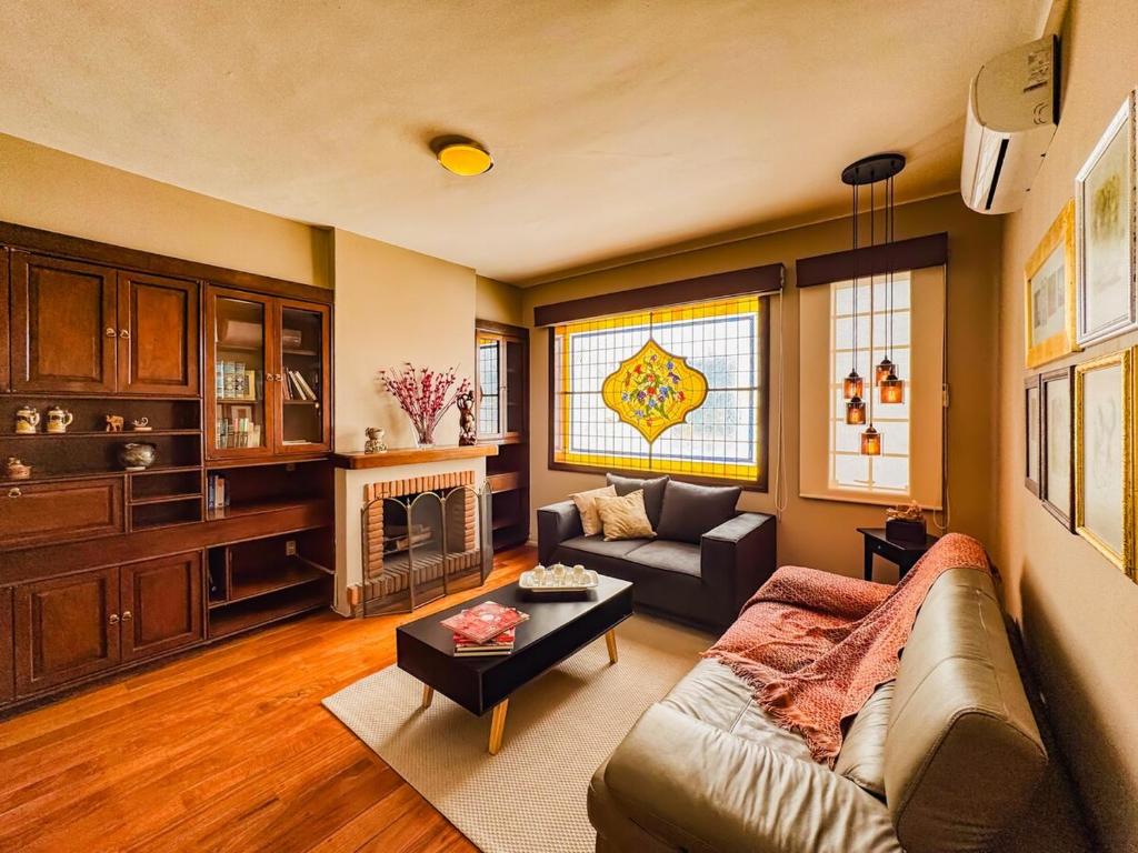 a living room with a couch and a fireplace at Departament en Polanco, CiudadDeMéxico in Mexico City