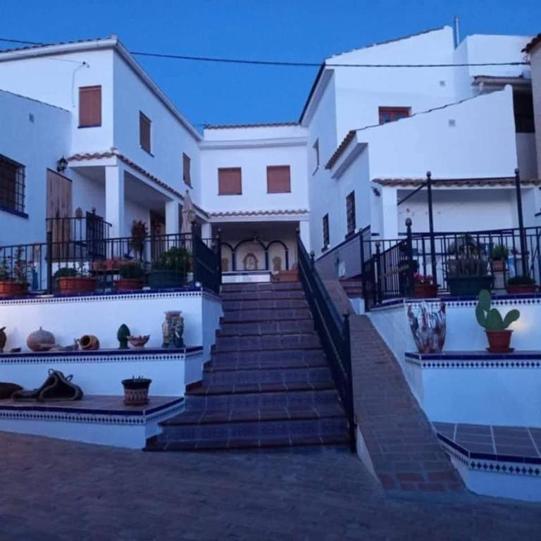 a house with stairs in front of it at Casa De Aventuras in Bácor