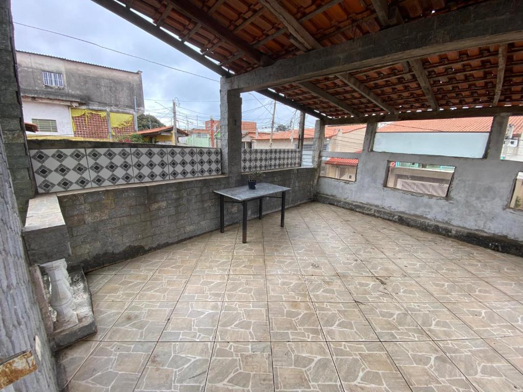a patio with a table on top of a building at Casa MISMA in Sao Paulo