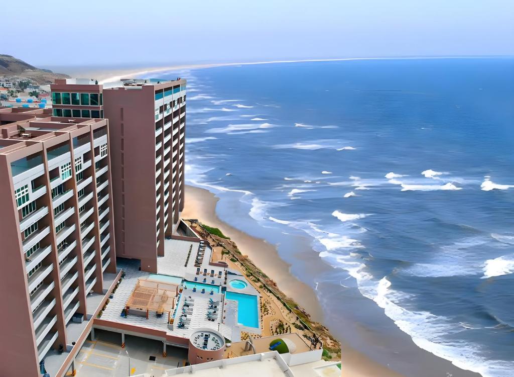 an aerial view of a hotel and the beach at Luxury Beach Condo with Pool in Tijuana
