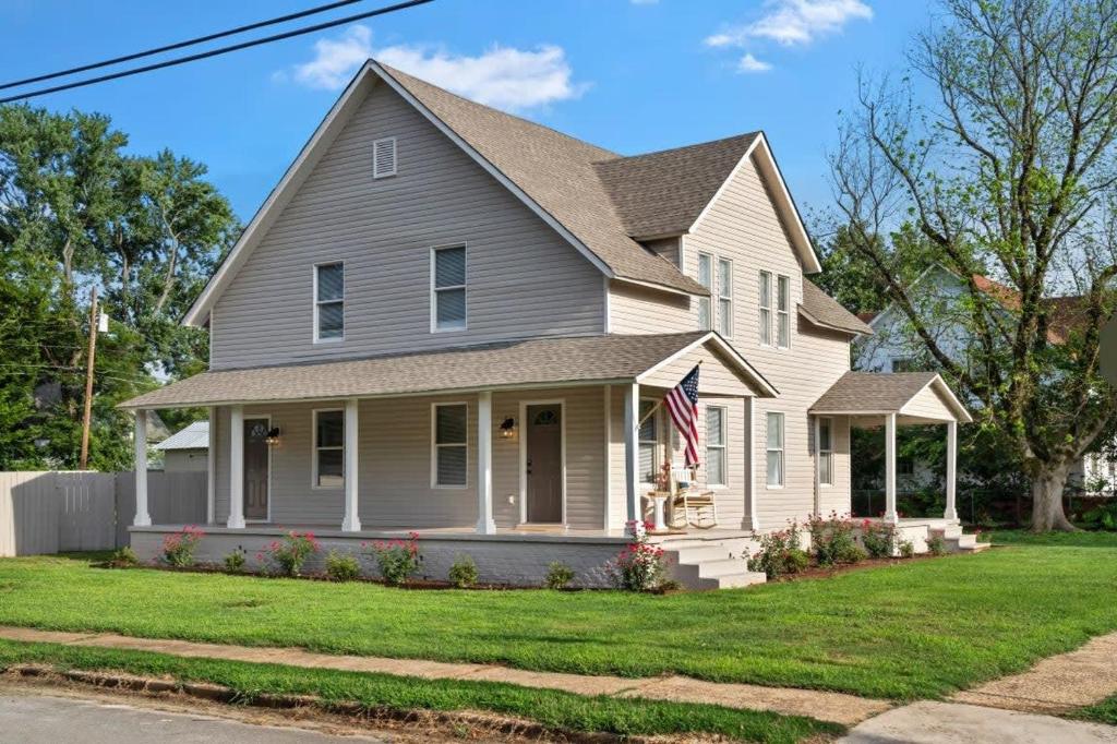a house with a flag in the front yard at Bradley Blissful in Chelsea