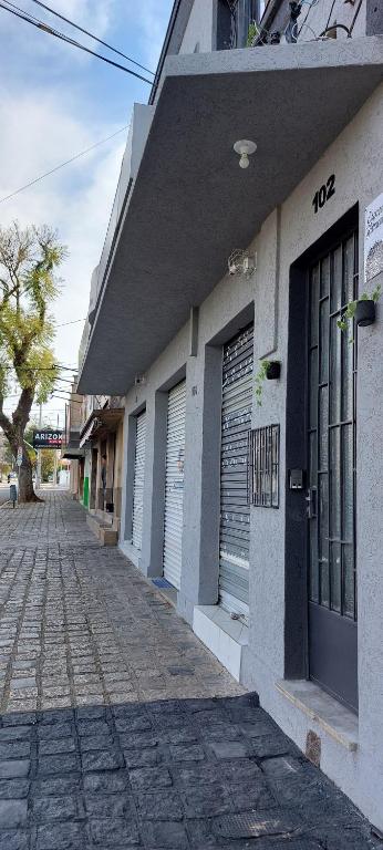 a row of doors on a building on a street at Espaço Harmonia - um apartamento inteiro e aconchegante para vc! in Curitiba