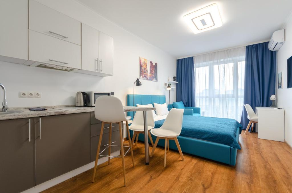 Un dormitorio con una cama y una mesa y sillas. en Petrovdom Apartments 20-199в in RC Kvartet, 16г Lypkivskoho Street, en Kiev