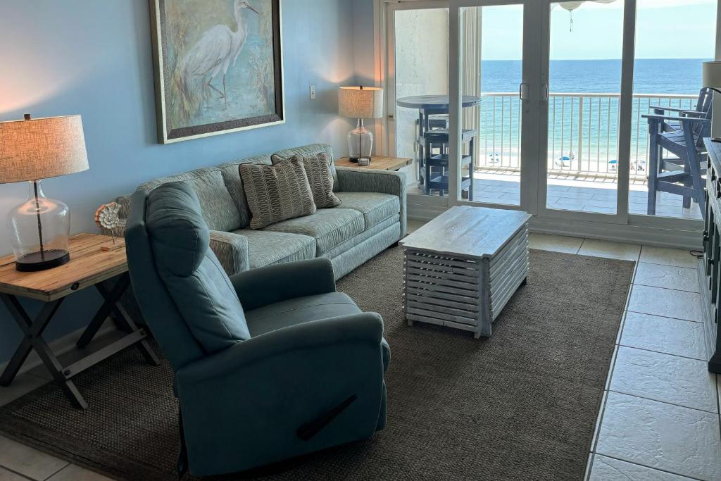 a living room with a couch and a table at Castaways 7C in Gulf Shores