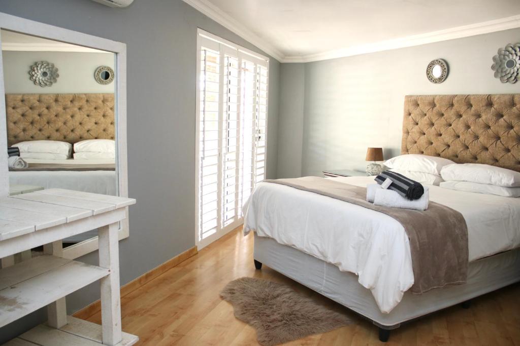a bedroom with a bed and a desk and a mirror at Serene living in East London