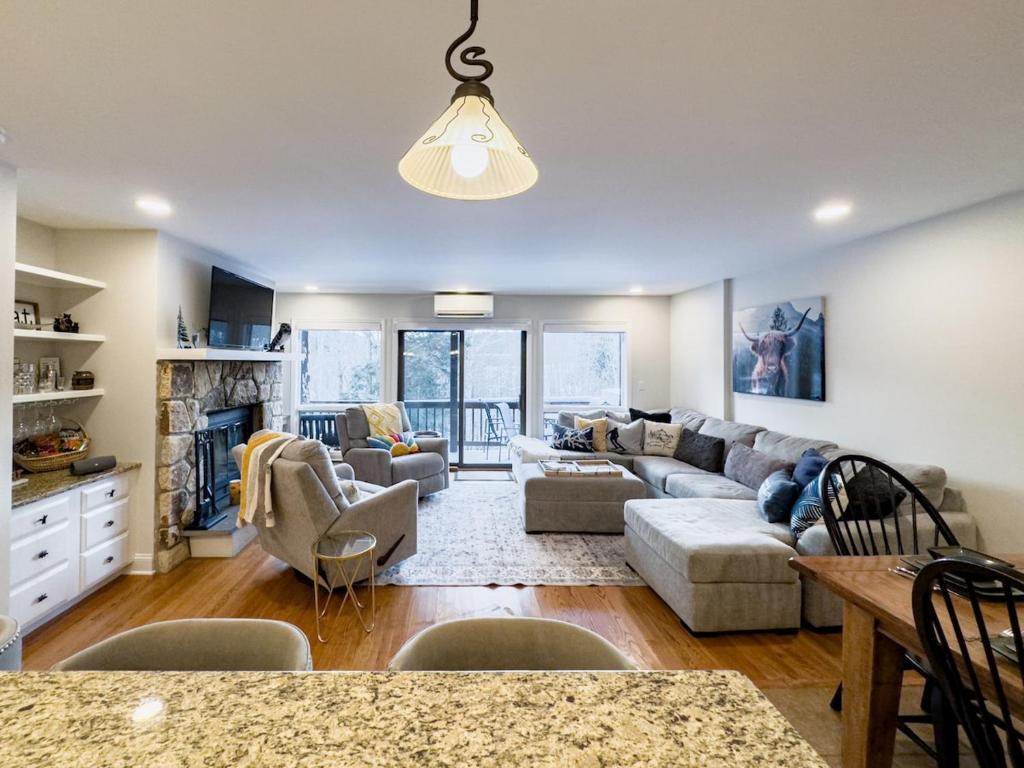 a living room with a couch and a table at NEWLY REMODELED FOUR BEDROOM All SEASON CONDO W MOUNTAIN VIEWS in East Jewett