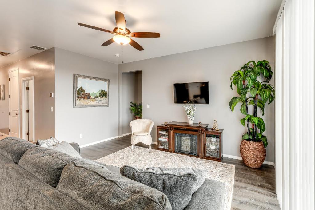 a living room with a couch and a ceiling fan at Ski, Hike and Explore Bellemont Home with Fenced Yard in Bellemont