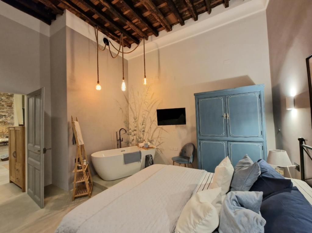 a bedroom with a large bed and a bath tub at Erbe12 loft&park historic apartment centro città in Genoa