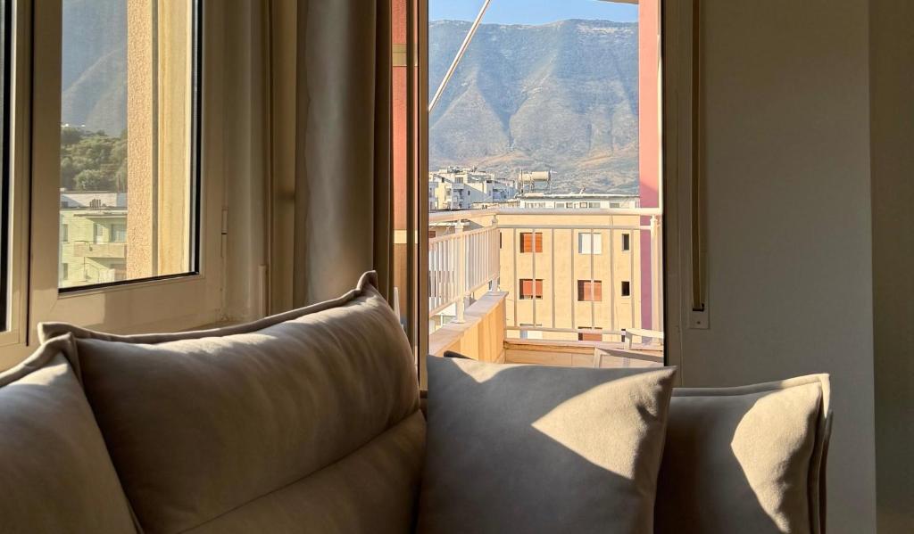 a couch sitting in front of a window with a view at Orikum Getaway in Orikum