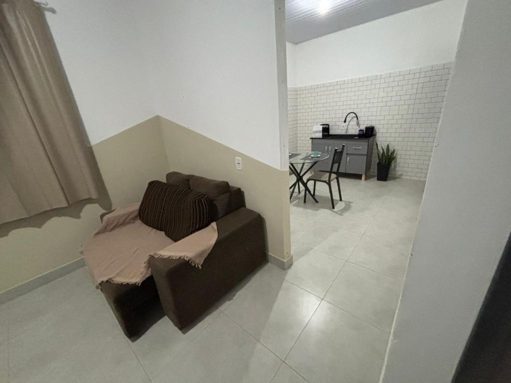 a living room with a couch and a table at Casa GZ - Quarto 01 - Ideal para quem vem a Sinop a trabalho! in Sinop