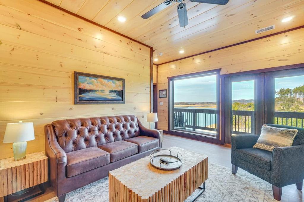 a living room with a couch and a table and chairs at Lakeside Bear Lodge in Sevierville
