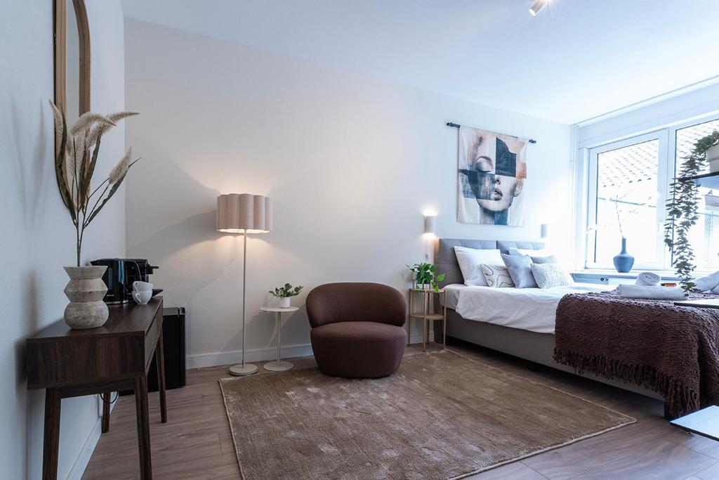 a bedroom with a bed and a chair and a window at Nature Budget Bedroom Near University Tilburg in Tilburg