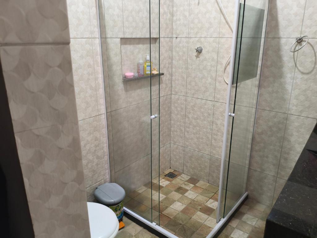 a shower with a glass door in a bathroom at Casa Avance RH Aconchego in Camaçari