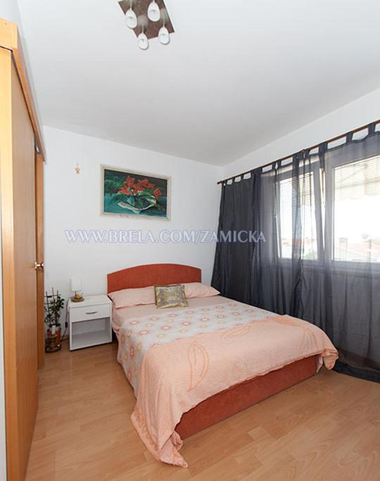 Postel nebo postele na pokoji v ubytování Apartments Zamicka