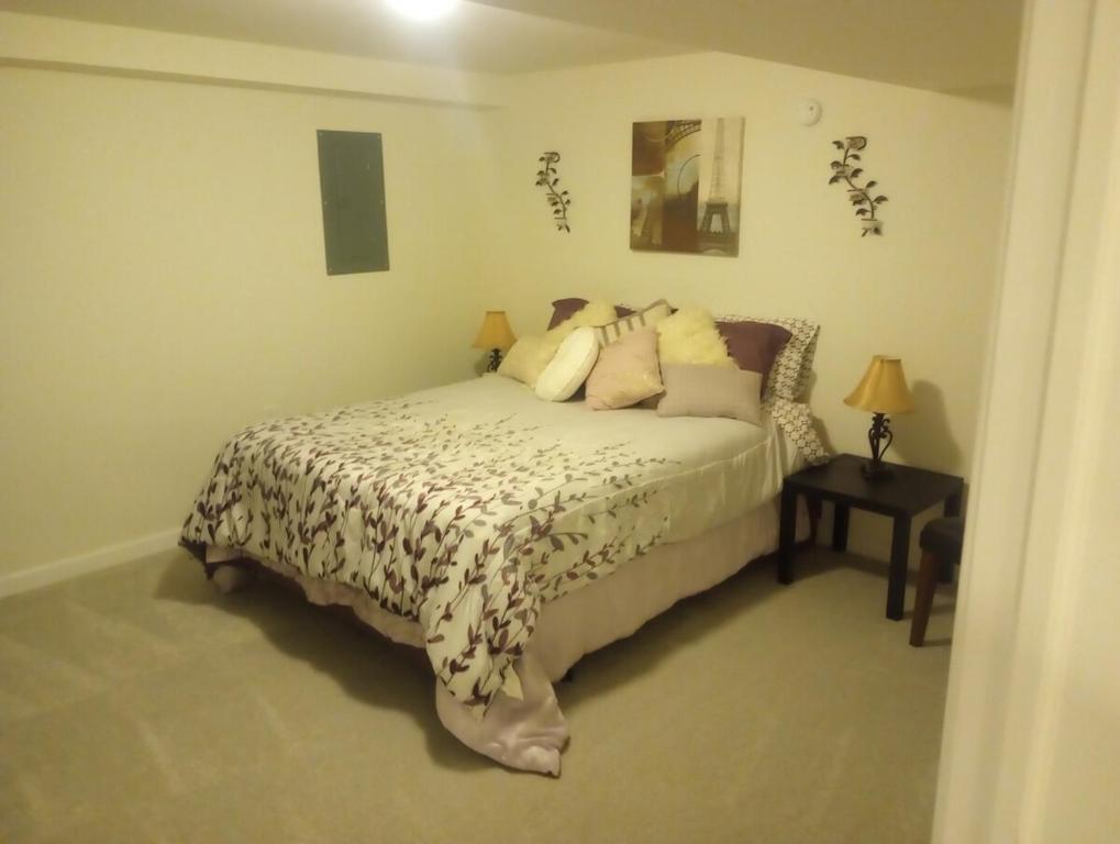 a bedroom with a bed and a side table at Brand new apartment in seaford 