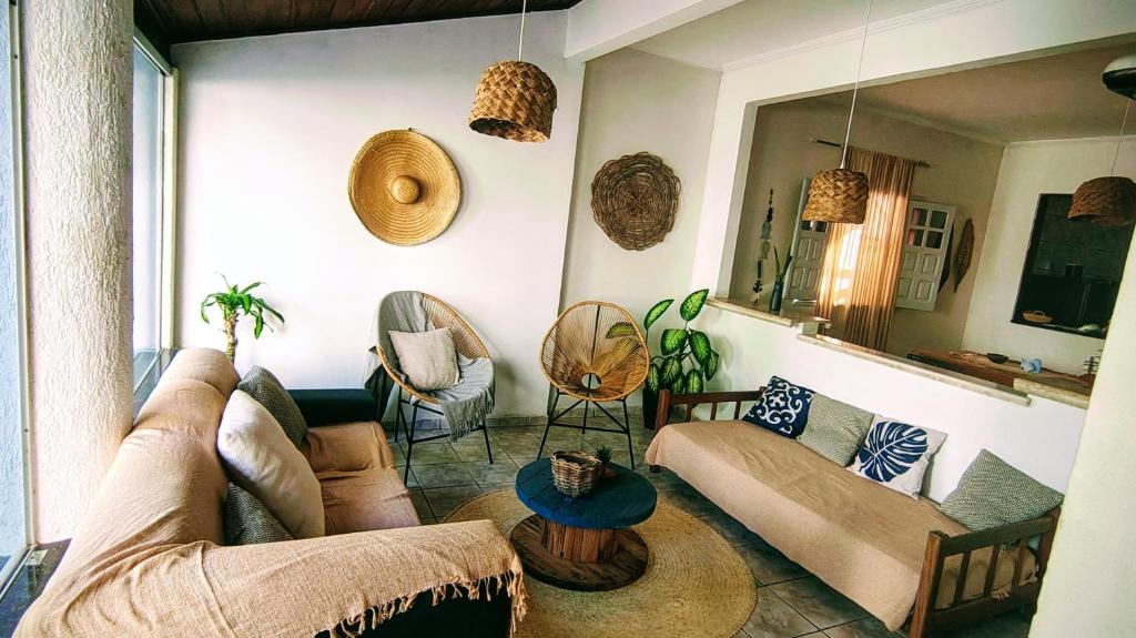 a living room with a couch and a table at Casa & Mar in Porto Seguro