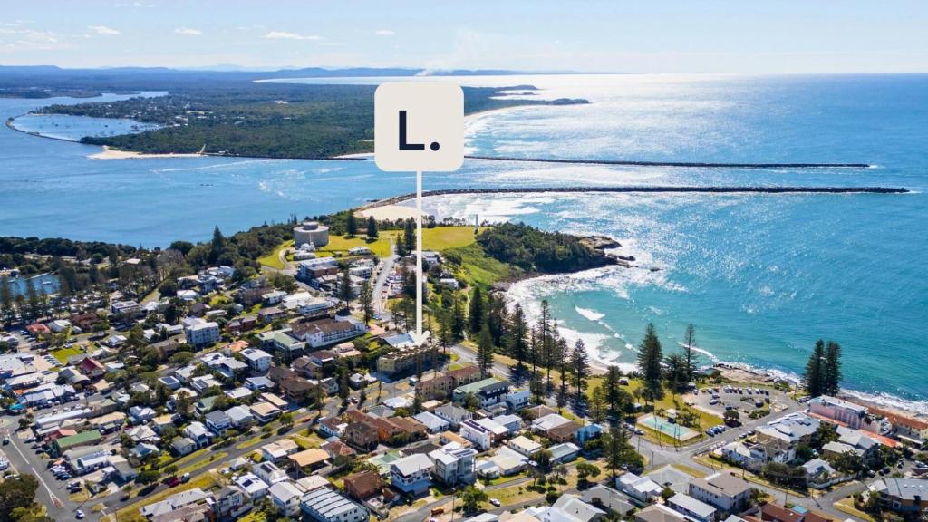 an aerial view of a city and the ocean at Seaspray Breeze - Lifestyle Yamba in Yamba