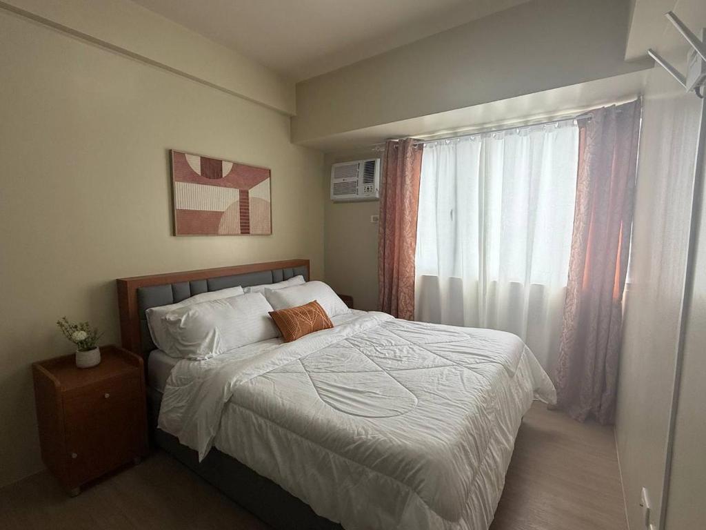 Ένα ή περισσότερα κρεβάτια σε δωμάτιο στο Avida Dos in Iloilo City Ayala Property Rentals by Madz