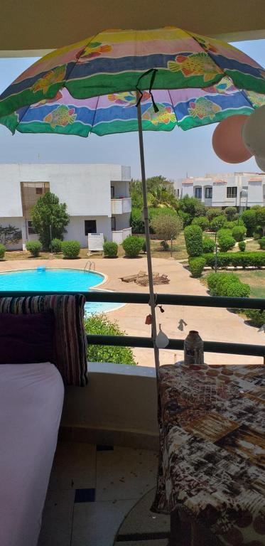 a view of a patio with an umbrella and a pool at شقة للايجار in Sharm El Sheikh