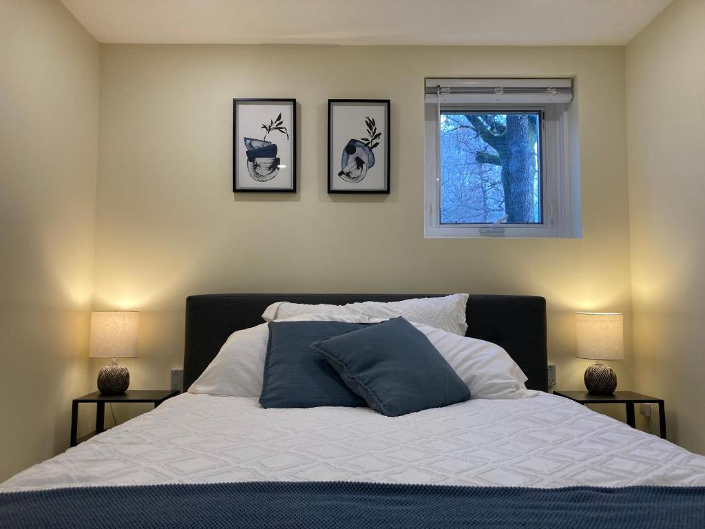 a bedroom with a bed with three pictures on the wall at Private Suite in Vancouver in Vancouver