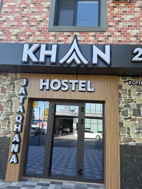 a building with a sign for a hospital at Khan Hostel in Shymkent