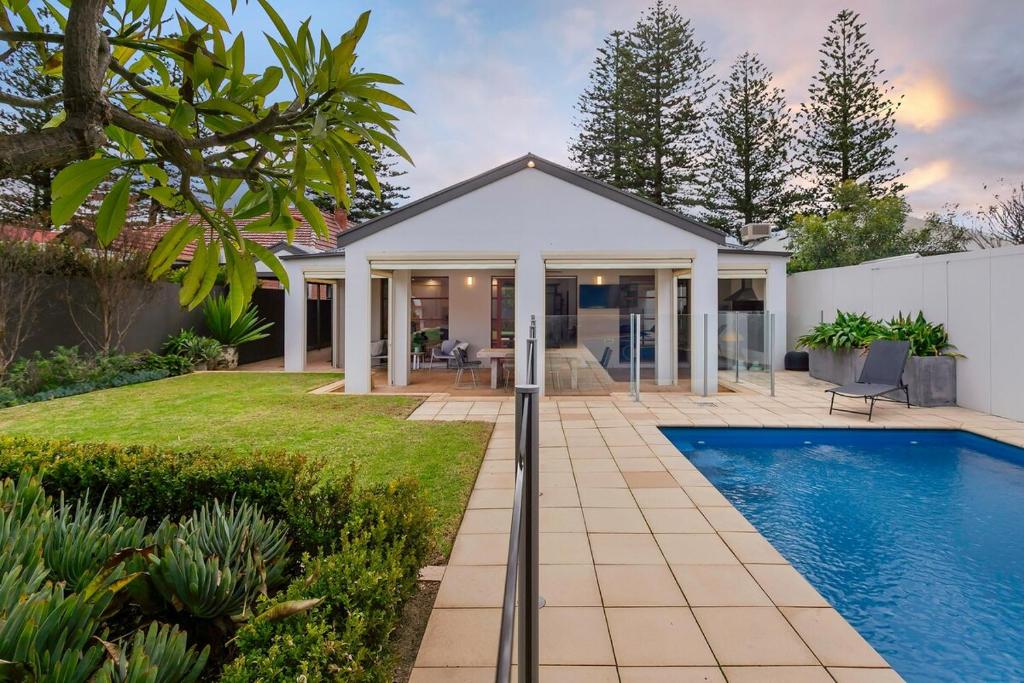 a home with a swimming pool in the yard at Henley Beach House - Luxury by the Sea in Henley Beach