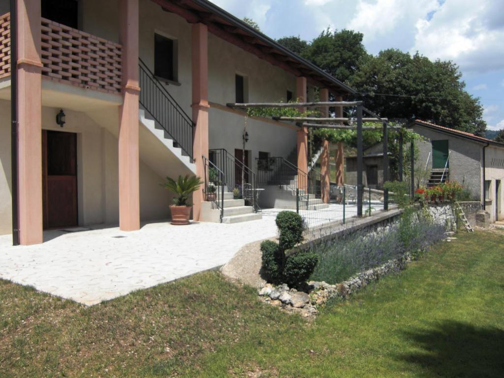 a house with a plant in the grass in front of it at Il Giardino di Lavanda in Montesano sulla Marcellana