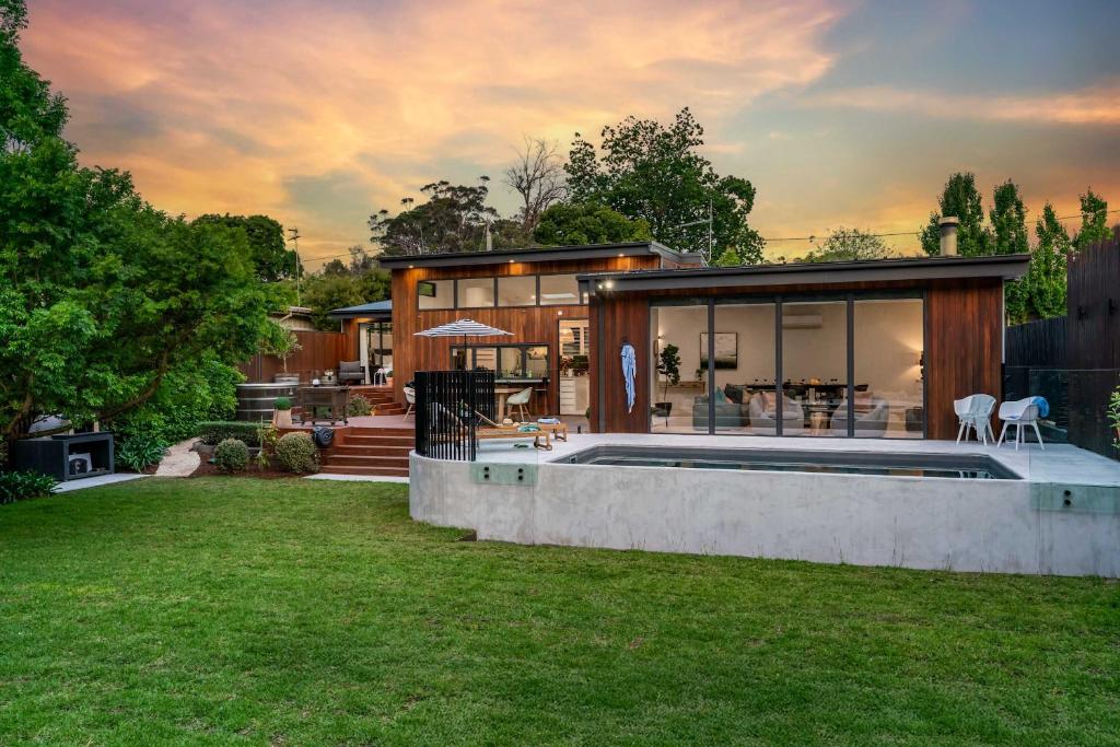 a house with a swimming pool in a yard at Hiraeth - Pool Spa Beach & Village in Mount Martha