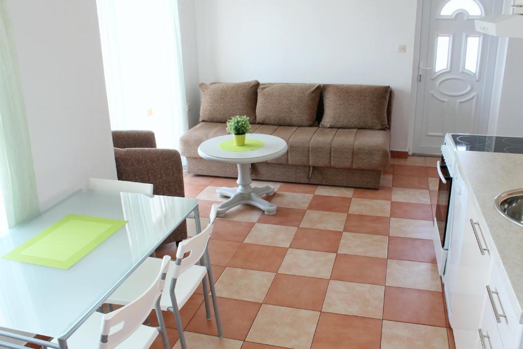 a living room with a couch and a table at Apartments Villa Milna 1 in Budva