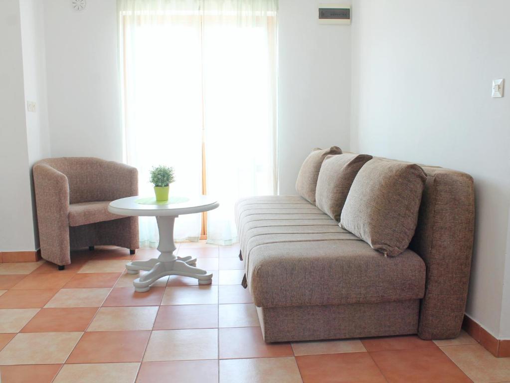 a living room with a couch and a table at Apartments Villa Milna 1 in Budva
