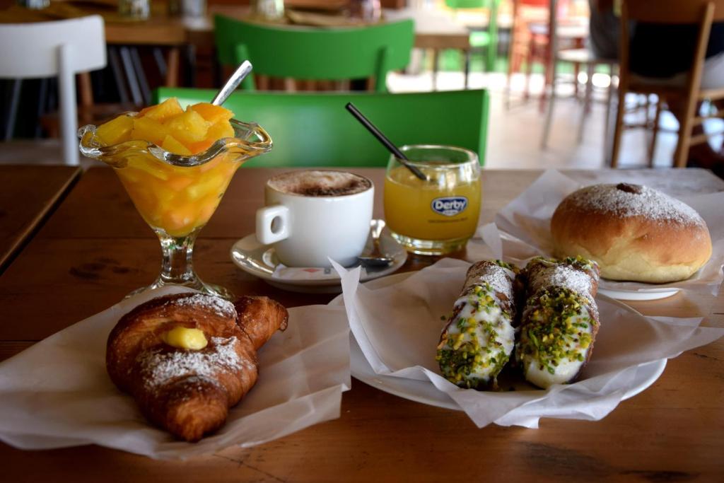 a table with pastries and a drink and a table with pastries at La Casa del Geko in Cefalù