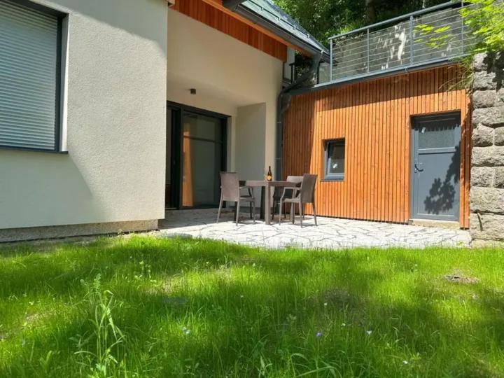 a patio with a table and chairs next to a building at Apartmány U Buku in Jablonec nad Nisou