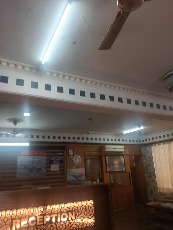 a restaurant with a sign on the ceiling at Home Sweet place in Meerut