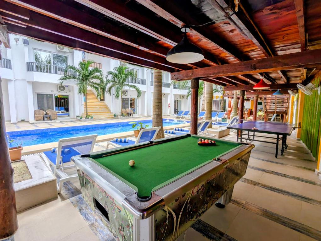 a pool table in the middle of a room with a pool table at Golden Hotel in Nungwi