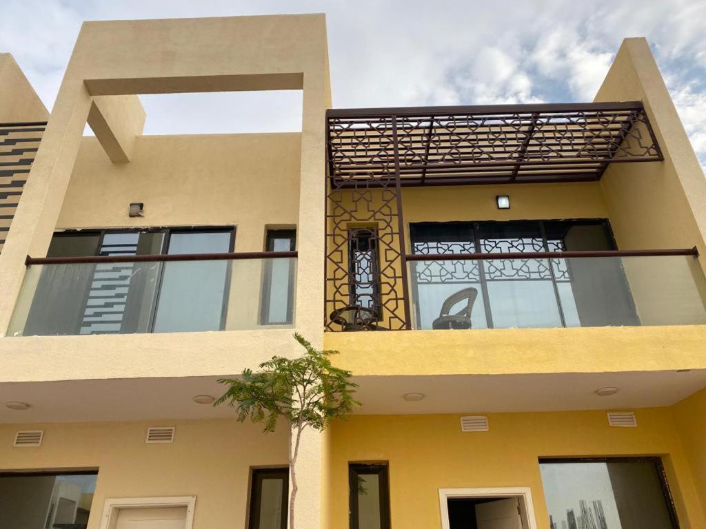a building with a balcony on the side of it at 3 Bhk Villa in Prime Location in Dubai