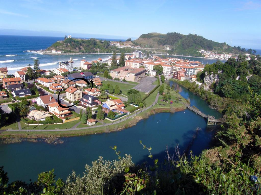 an aerial view of a town next to the ocean at Apartamentos la Marina in Ribadesella