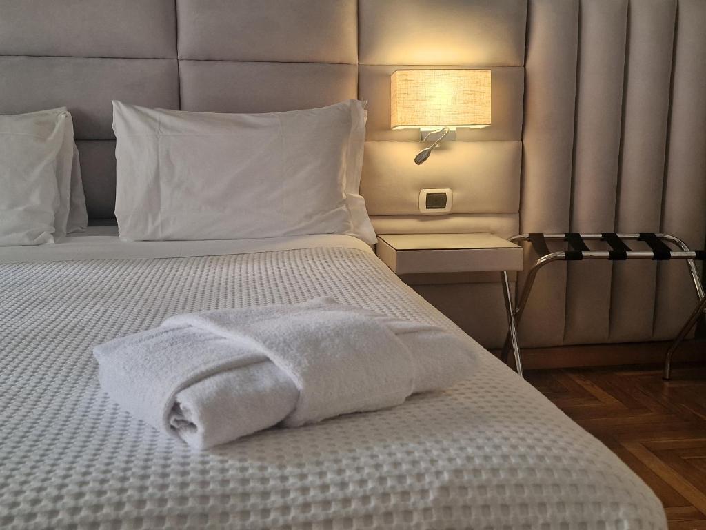 a bed with two towels sitting on top of it at Sweet Home Parioli in Rome