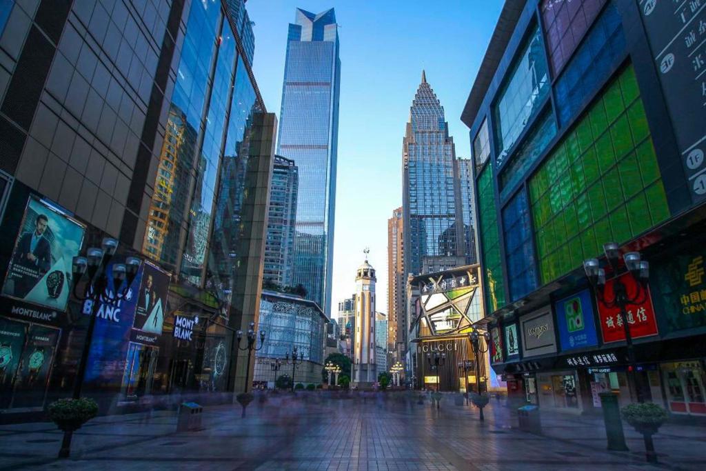 a city street with tall skyscrapers in a city at Pilot Hotel in Chongqing