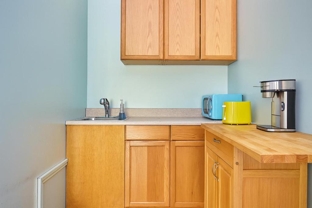 a kitchen with wooden cabinets and a sink at Malibu 2BR In Woods Close To Beach in Malibu