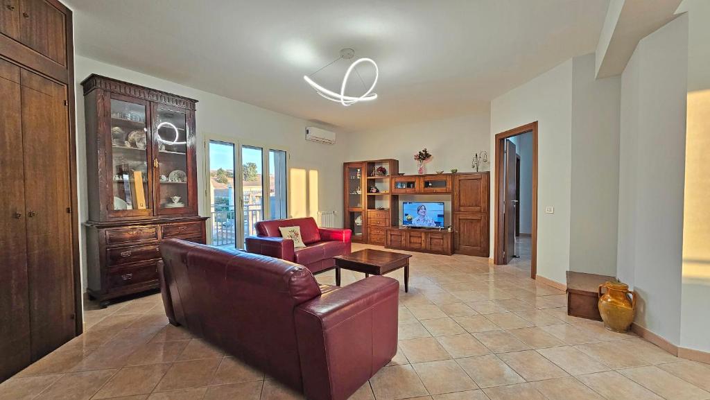 a living room with a couch and a table at Tenute D'Angelo - Holidays, Relax & Wellness - Casa vacanze ad Agrigento in Agrigento