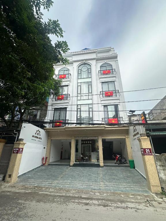 a large white building with a courtyard in front of it at An Dương Hotel in Lạng Sơn