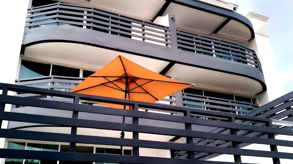 an orange umbrella hanging from the side of a building at VS Beach Front in Jomtien Beach