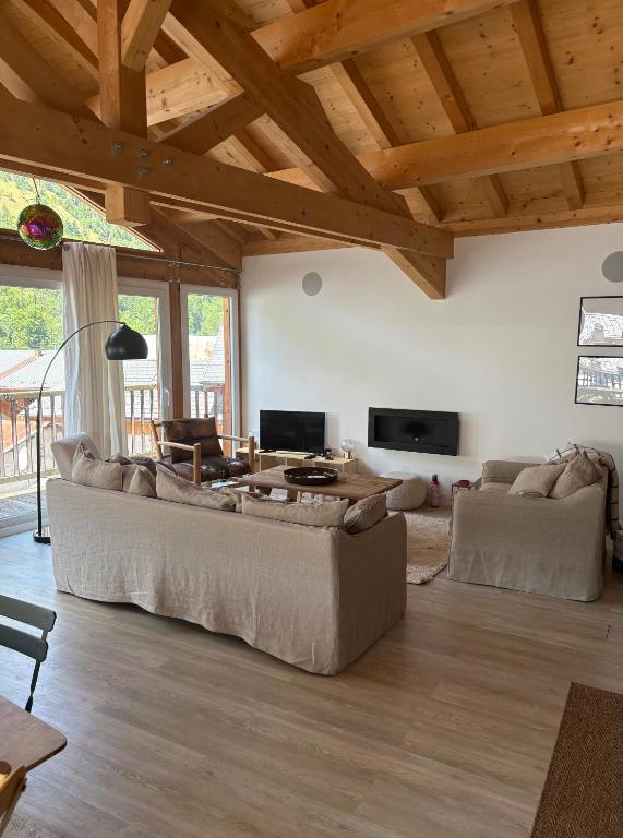 a living room with a couch and a table at Chalet Belleville in Béranger