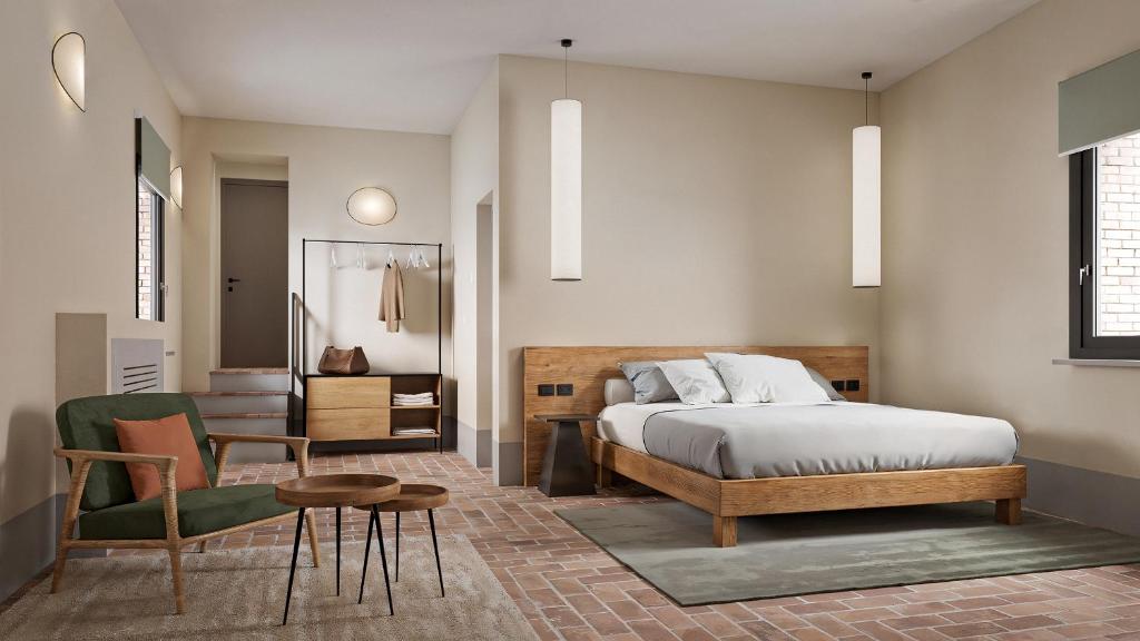 a bedroom with a bed and a chair and a table at The Monteleone Umbria Retreat in Monteleone dʼOrvieto