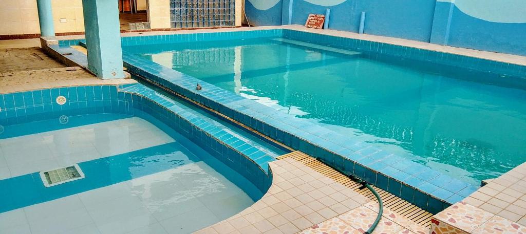 Una gran piscina con azulejos azules en un edificio. en Shanzu Gem, en Mombasa