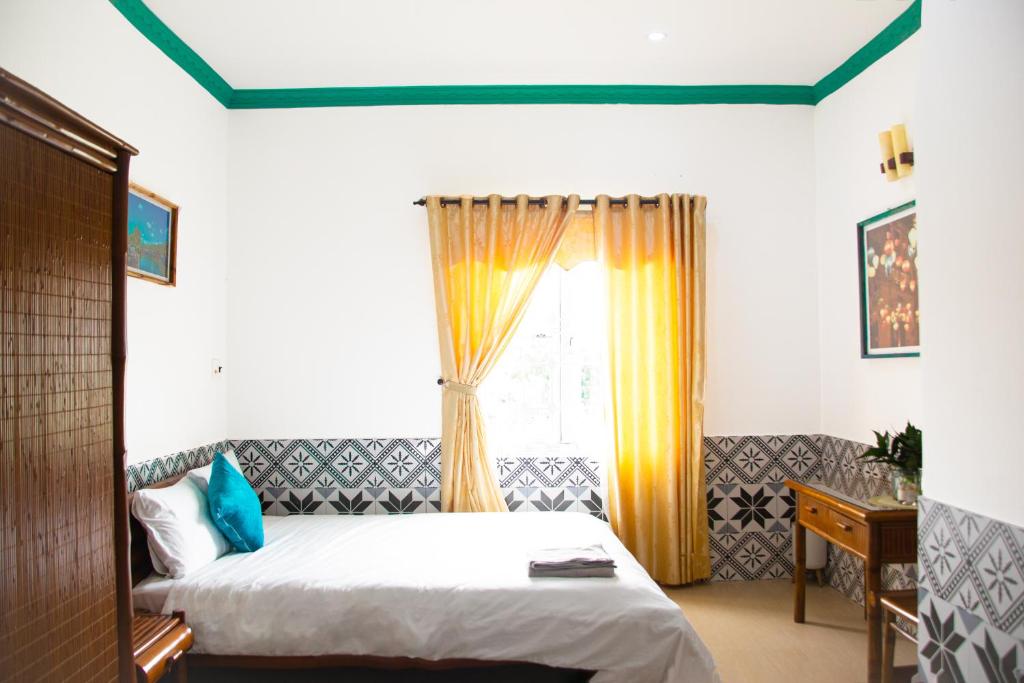 En eller flere senge i et værelse på Cy'Home Đà Nẵng