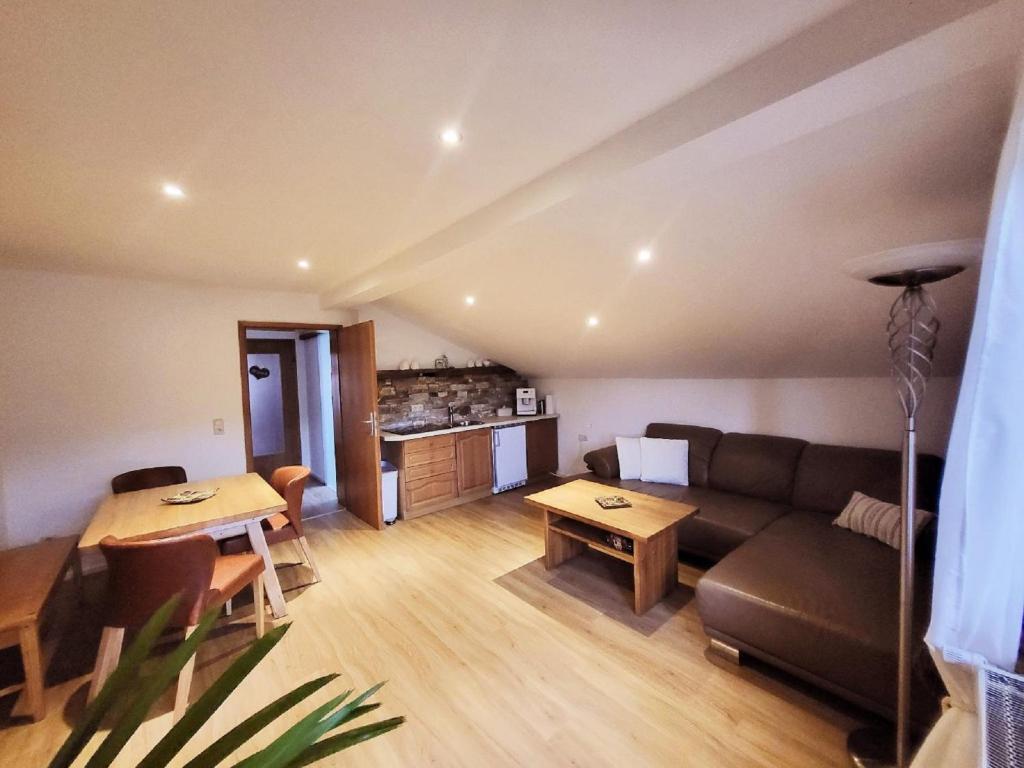 a living room with a couch and a table at Ferienwohnung Goldfasan in Lam
