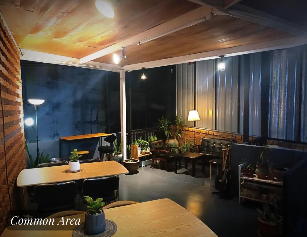 a room with tables and chairs in a building at Friend Nest Bangkok in Bangkok
