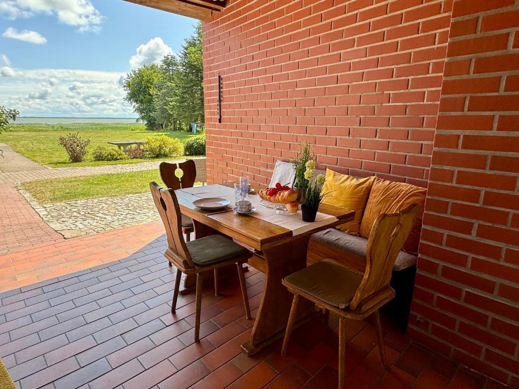 a wooden table and chairs on a patio at FERIENWOHNUNGEN Krull App 02 in Ahrenshoop